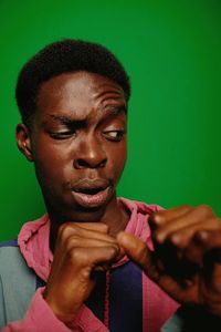 Low angle view of young man against blue background
