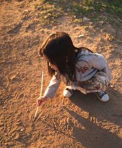 High angle view of girl on sand