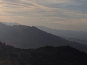 Scenic view of mountains against sky at sunset