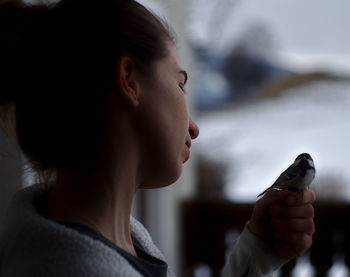 Portrait of woman holding camera