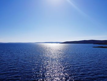 Scenic view of sea against clear blue sky