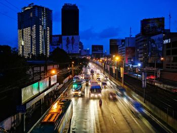 Illuminated city street and buildings at night