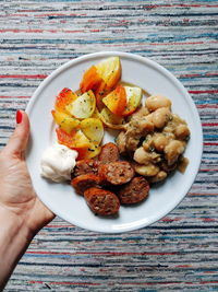 High angle view of hand holding food on table