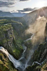 Scenic view of waterfall against sky