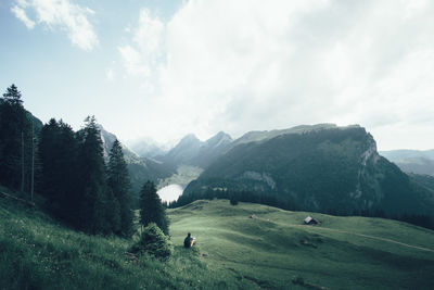 Scenic view of mountains against cloudy sky