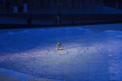 People in swimming pool against sky