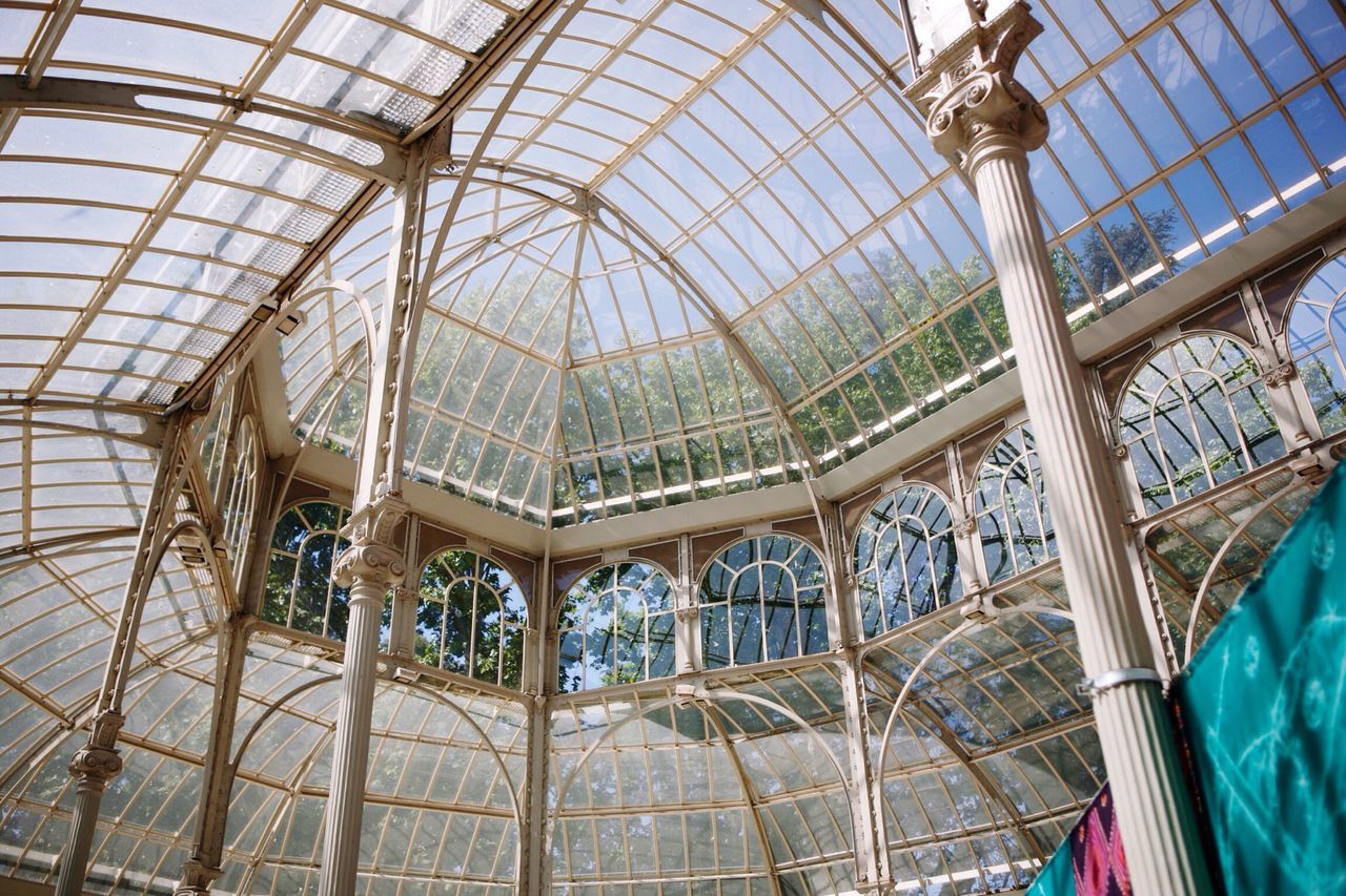 indoors, ceiling, built structure, architecture, glass - material, pattern, metal, low angle view, window, railing, architectural feature, interior, day, transparent, no people, skylight, design, sunlight, staircase, modern