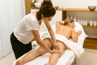 Woman massaging customer at spa