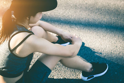 Rear view of woman sitting outdoors