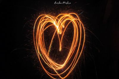 Close-up of illuminated light painting against black background