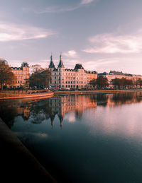 Reflection of building in river during sunset