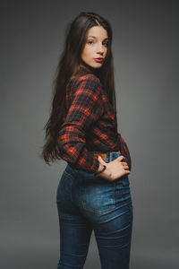 Portrait of beautiful young fashion model with wig against gray background