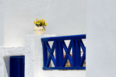 Flower vase against white wall