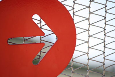 Low angle view of stop sign on red wall