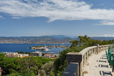 View of town by sea against sky