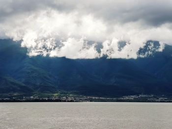 Scenic view of land and mountains against sky