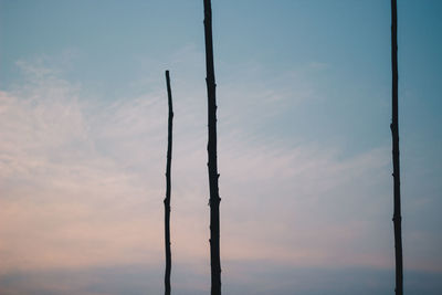 Low angle view of silhouette pole against sky during sunset