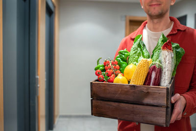 Midsection of woman holding food on table