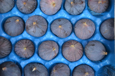 Full frame shot  of figs in blue plastic at the grocery store