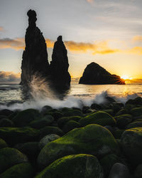 Waves breaking over rocky beach at dawn with seastacks