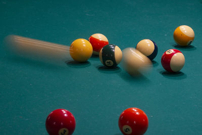 Blurred motion of pool balls on table