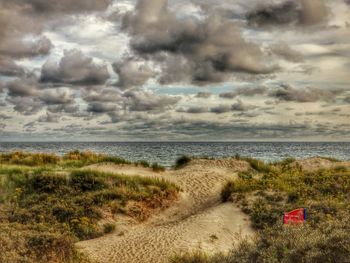 Scenic view of sea against cloudy sky