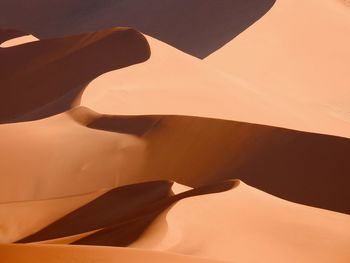 High angle full frame view of orange sand dunes in desert