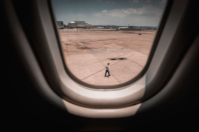 Man seen through airplane window