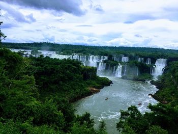 Scenic view of waterfall against sky