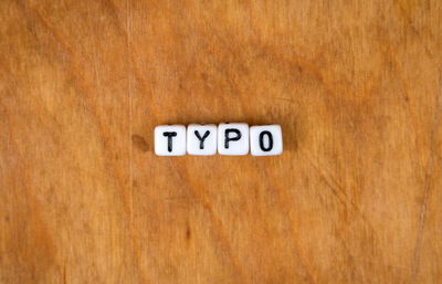 Close-up of information sign on wooden table