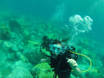 High angle view of woman scuba diving in sea