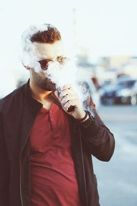 Young man smoking cigarette