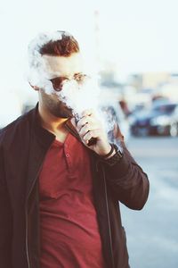 Young man smoking cigarette