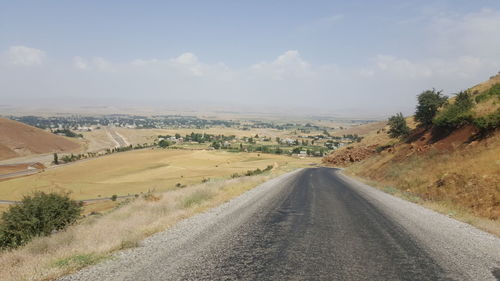 Road amidst landscape against sky