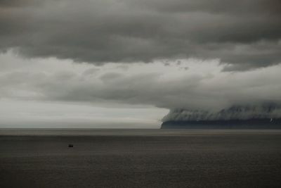 Scenic view of sea against cloudy sky