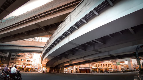 People walking on bridge in city