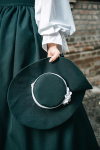 Green vintage hat 1800s early 1900s clothing in female hand.