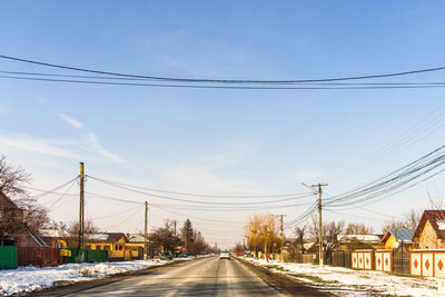 Cars on road against sky in city