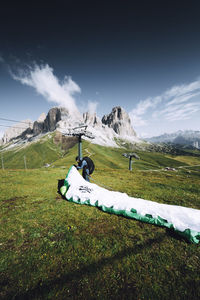 Scenic view of field and snowcapped mountains against sky