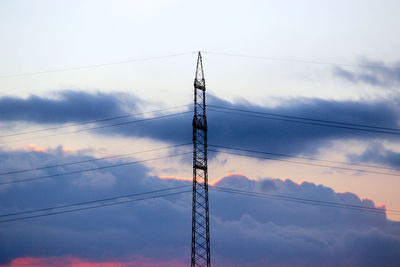 Low angle view of electricity pylon against sky