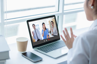 Midsection of man using laptop at office