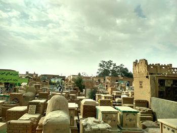 Cemetery against buildings in city against sky