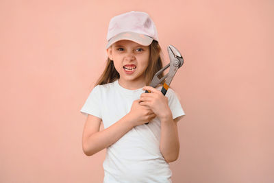 Portrait of young woman holding tape measure