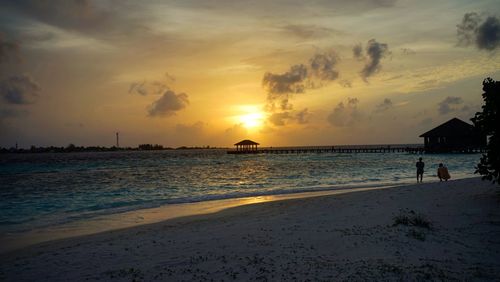 Scenic view of beach against sky during sunset