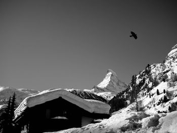 Low angle view of snowcapped mountains against sky