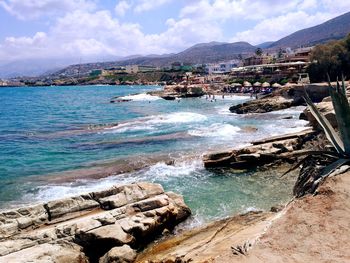 Scenic view of sea and mountains against sky