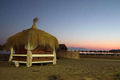 Built structure on beach against clear sky