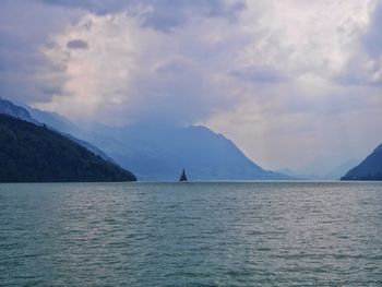 Scenic view of mountains against cloudy sky