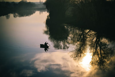 Silhouette person in a lake