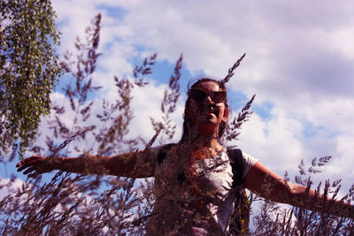 Low angle view of young man against sky